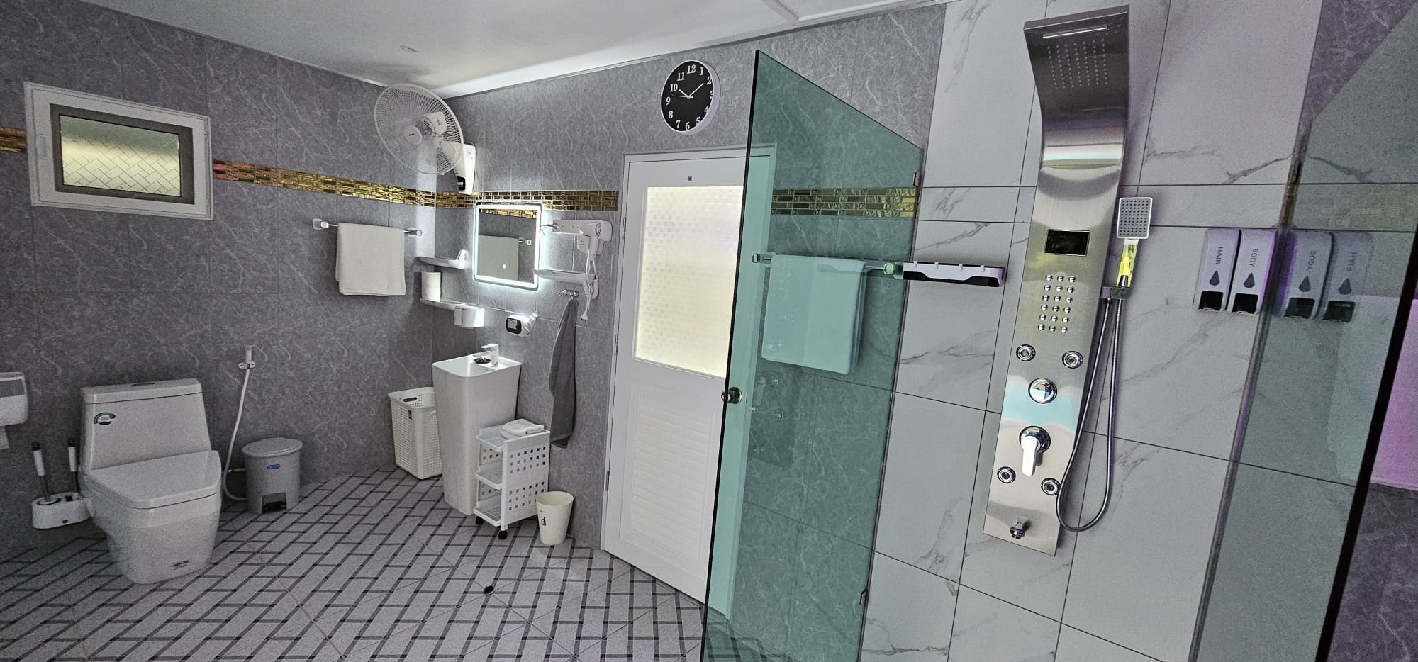 Bathroom with a glass walk-in shower and marble-look tiles